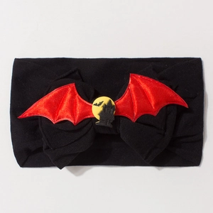 Detail of Halloween baby headband with red bat wings and castle silhouette on black nylon