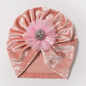 Detail of soft pink velvet baby turban hat with delicate layered mesh flower decoration