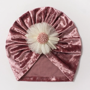 Detailed texture of velvet baby hat with mesh flower and soft decorative ribbon