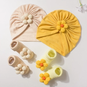 Newborn baby hat and socks set with cute fabric flowers in beige and yellow