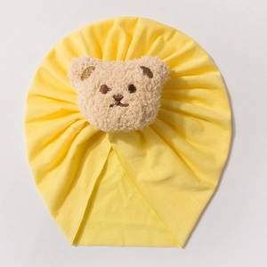 Yellow baby turban hat featuring a 3D plush bear head in soft breathable cotton fabric