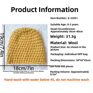 Detail showing bright yellow knitted baby hat with clear weaving texture and dimensions