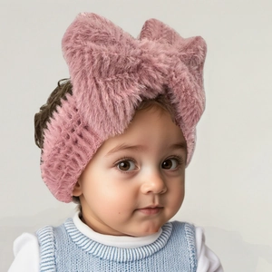 Detail of pink plush baby headband with soft fuzzy bow for infants winter accessories