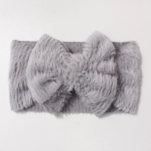 Plush grey infant headband with a large oversized bow for winter warmth and style