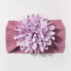 Detail of baby headband with pink knitted texture and large floral polka dot pattern