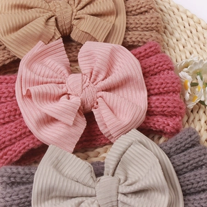 Chic knit baby headbands with large bows in various soft colors for winter warmth