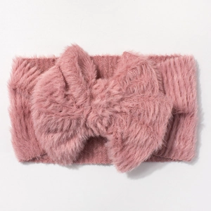 Close-up of pink plush bow headband with soft long fleece texture and elastic band