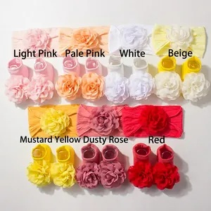 Detail of baby headband and socks set featuring large layered fabric flower designs