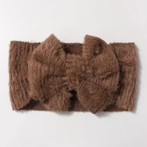 Detail view of plush brown baby headband featuring a soft fluffy bow texture for warmth
