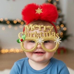 Detailed view of baby Christmas set featuring a gold glitter glasses and red pompom headband