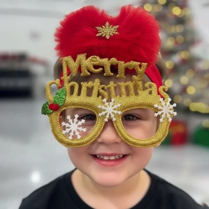 Close-up of golden glitter Merry Christmas headband with red pom-pom and holly for kids