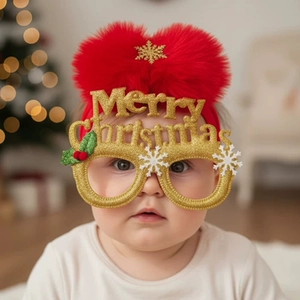 Detail of baby Christmas glasses and headband featuring red fuzzy pom and Merry Christmas text