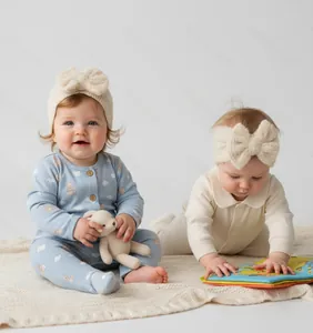 Close-up of baby knit romper and large bow headband set with cute bear patterns