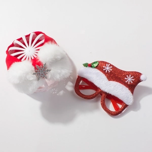 Close-up of Christmas baby accessory set with red snowflake headband and glitter Santa glasses