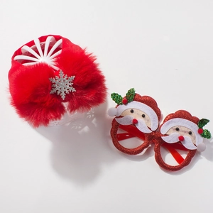 Close-up of baby Christmas set featuring a red sequin Santa glasses frame and snowflake headband