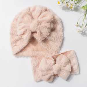 Pink plush baby winter set with a soft bow beanie hat and matching wide headband