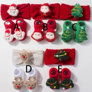 Detail view of festive baby Christmas sets including knitted headbands and doll socks