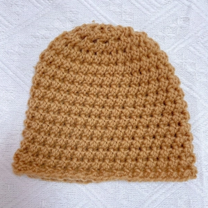 Thick knitted baby beanie in caramel brown with honeycomb texture for winter warmth