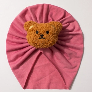 Pink baby turban hat made of soft cotton with a cute brown plush bear decoration