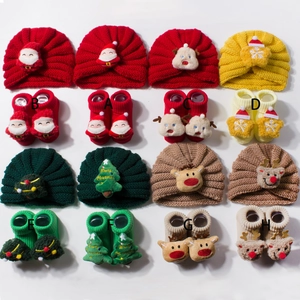 Detail view of eight cute Christmas themed knitted baby hat and sock gift sets for winter