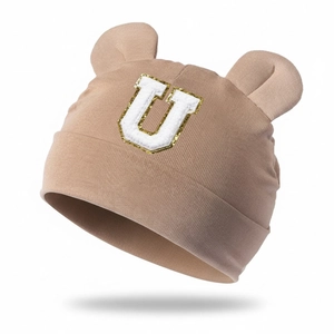 Detail of khaki modal baby beanie with bear ears and sequined letter U patch embroidery