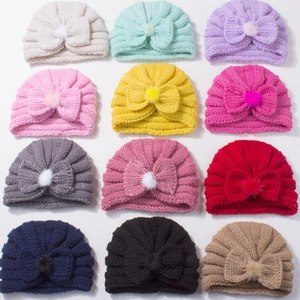 Set of 12 colorful baby knit turban hats with soft bow and faux fur pompom details