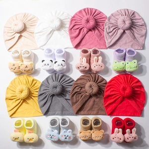 Cute cartoon baby hat and sock set in various colors featuring soft knitted cotton fabric