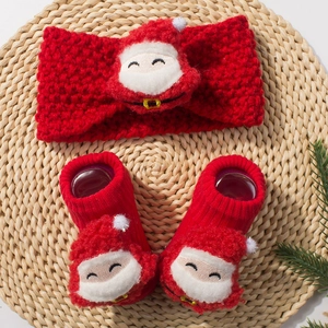 Christmas baby set with red knit headband and matching socks featuring plush Santa decor