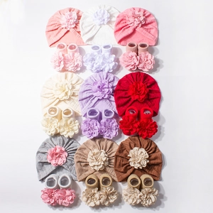 9-color baby hat and socks set featuring large handmade fabric flowers on soft knit fabric