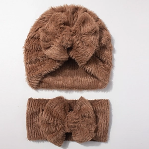 Close-up of the warm caramel brown plush texture on the baby hat and headband set