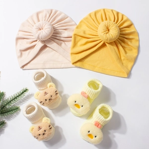 Soft baby beanie and socks set with cute cartoon tiger and duck details in pastel colors