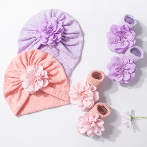 Infant beanie and socks set with decorative fabric flowers in purple and pink