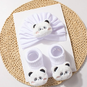 Detail view of baby knitted hat and socks set featuring cute plush panda faces in white