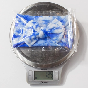Detailed weight measurement showing 12.9g for a tie-dye nylon bow baby headband