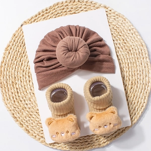 Cute brown knotted baby beanie and yellow bear socks set for autumn and winter comfort