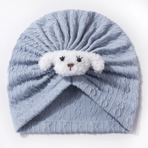 Detail view of light blue knitted baby hat with soft plush puppy face and cable knit pattern