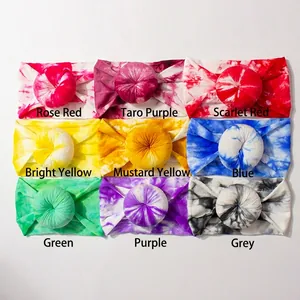 Detailed view of nine colorful tie-dye nylon headbands with cute donut knots for infants