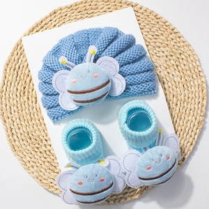 Sky blue knit baby hat and socks set featuring cute plush bee patches for warmth