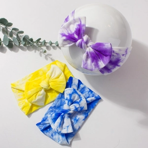 Three-piece set of tie-dye baby bow headbands in purple, yellow, and blue soft fabric