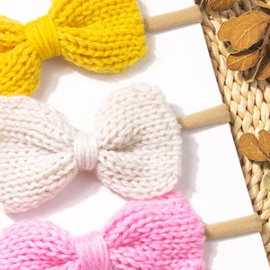 Three-piece set of knitted bow headbands in yellow, beige and pink for babies