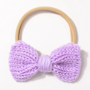 Close-up of a purple knitted bow headband with high elasticity seamless band for infants