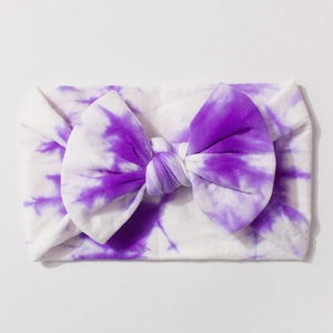 Elastic purple tie-dye baby headband with a large decorative bow for infants
