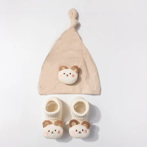 Newborn baby modal bear hat and socks set with 3D teddy decor on white background