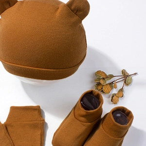 Detail of newborn knit set with bear ear hat, socks and anti-scratch mittens in caramel brown