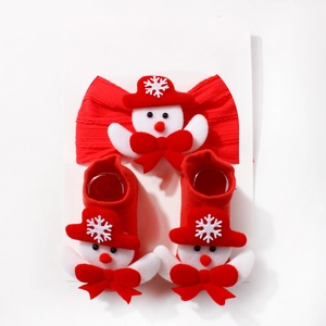 Close-up of baby Christmas headband and socks set with cute 3D snowman dolls and bows