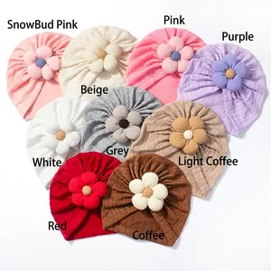 Detail showing nine colors of soft knit baby turban hats with large 3D flower decorations
