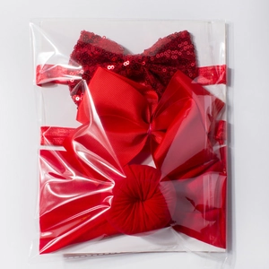 Three-piece red elastic baby headband set with sequins and bow ties on display card