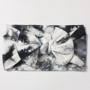Close-up of black and white tie-dye baby bow headband with soft knitted texture