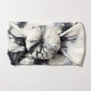 Detail of soft tie-dye nylon baby headband with unique donut knot and cloudy texture