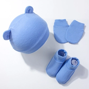 Three-piece newborn baby set with blue bear ear hat, mittens, and socks in soft cotton